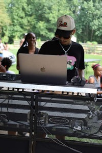 a man with a laptop in front of a crowd of people